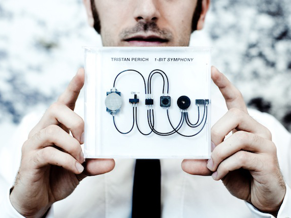 Tristan Perich holding 1 Bit Symphony — Photo taken from Hyperallergic.com